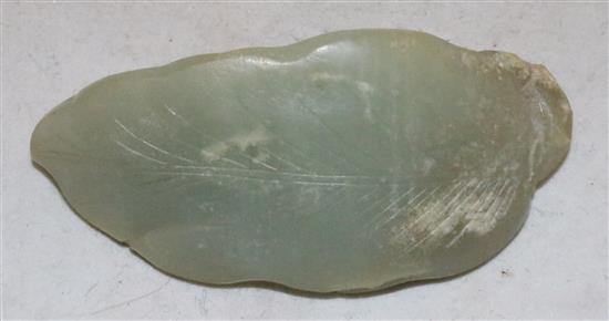 A Chinese celadon jade carving of a recumbent cat on a leaf, 18th / 19th century,